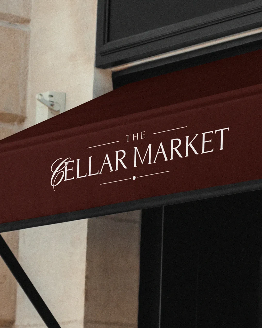 stone building facade design wine shop branding Vertical view of premium wine shop branding and signage on a historic stone exterior