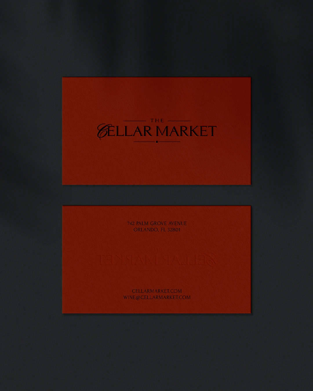 vertical premium business cards wine branding Vertical close-up of high-end business cards with custom wine shop monogram