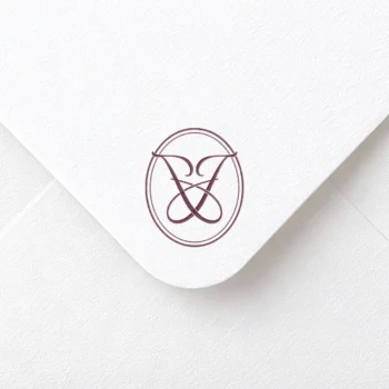 Red JJ initials logo with interlocking letters on rich textured paper for sophisticated wedding décor