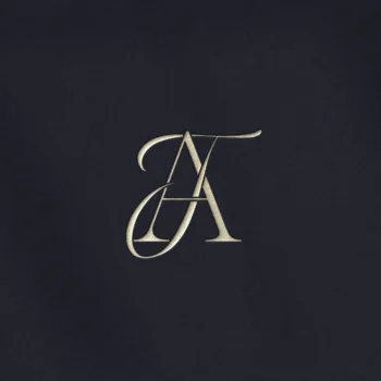 Silver TA & AT letter logo as minimalist design on a navy blue background for premium wedding stationery and branding