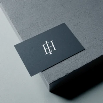 White EH letters as minimalist interlocking logo design on a business card for branding & high-quality stationery print