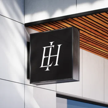 White EH lettermark as modern interlocking letter logo design on a signboard for high-end minimalist branding & business