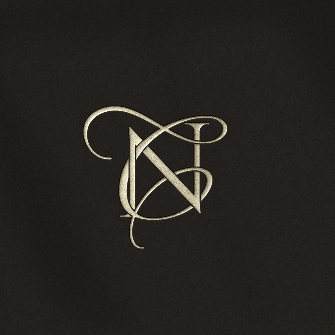 NC & CN Monogram | Elegant letter logo design Silver NC & CN wedding logo with interlocking letters on a rich brown background for luxury stationery, décor & branding