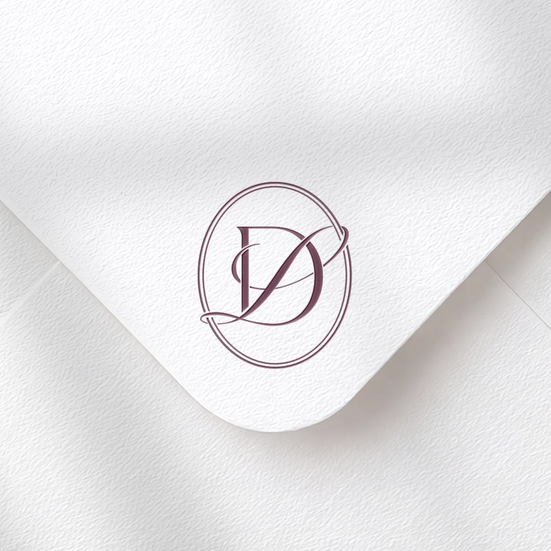 DL & LD Monogram | Elegant letter logo design Burgundy DL and LD initials as minimalist interlocking letter logo on textured envelope for luxury wedding stationery, print