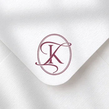 Light burgundy KI and IK wedding monogram with semi-bold interlocking letters as premium initials design on textured envelope for luxury stationery, invites, mailing and décor