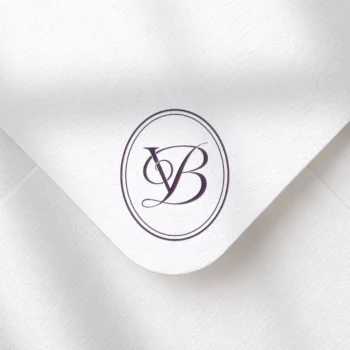 Lilac VB and BV letter logo as refined initials design on textured envelope for luxury wedding stationery suite and signage