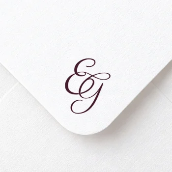 Rich burgundy EG letters as stylish initials logo design on a light textured envelope for sophisticated stationery suites, wedding décor, letterpress and high-quality print