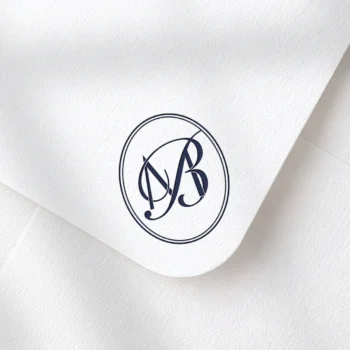 Rich navy blue MB and BM letters as stylish initials logo design on a light textured envelope for exquisite stationery suites, wedding décor and high-quality print